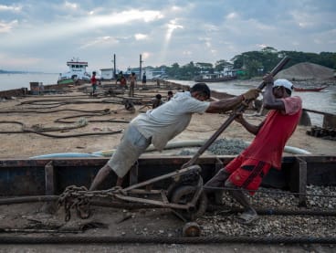 This photo taken on Jan 27, 2024 shows workers recovering a sunken ship in the Yangon River in Yangon. 