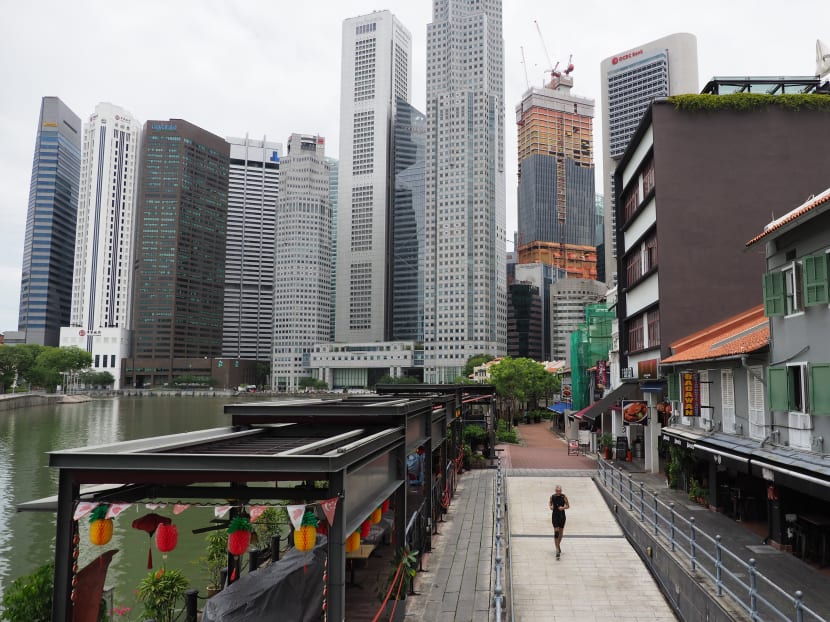 A man runs through Boat Quay during lunchtime on the first day of the circuit breaker on April 7, 2020.