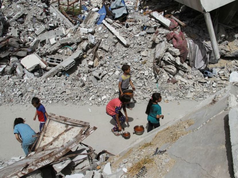 Children walk after receiving food, amid the ongoing conflict between Israel and the Palestinian Islamist group Hamas, in Jabalia, in the northern Gaza Strip April 22, 2024. 