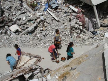 Children walk after receiving food, amid the ongoing conflict between Israel and the Palestinian Islamist group Hamas, in Jabalia, in the northern Gaza Strip April 22, 2024. 