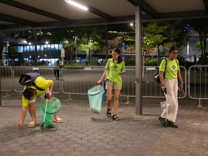 Stridy members and volunteers picking up litter before the Coldplay concert ends, outside the National Stadium, on Jan 23, 2024.