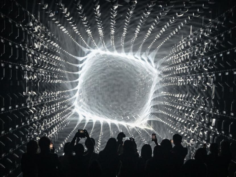 Visitors watch a light display during a tour of the new location for the digital art of Japanese collective "teamLab" at the recently opened 325m Azabudai Hills tower in Tokyo.