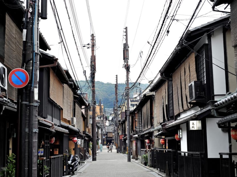 This picture taken on June 18, 2008 shows a street of the Gion district in Kyoto. Gion, the most famous neighborhood of Kyoto is also known as the Geisha district and is layered with teahouses and private clubs.