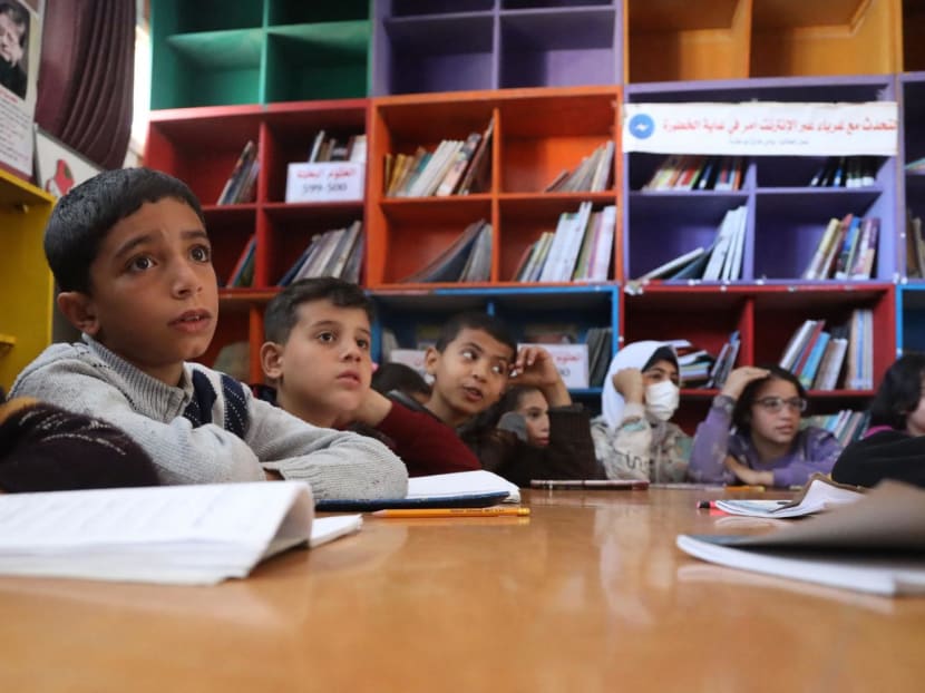 Displaced Palestinian children attend an English class in the library of the school housing displaced Gazans, in Rafah in the southern Gaza Strip on March 4, 2024, amid the ongoing conflict between Israel and Hamas. 