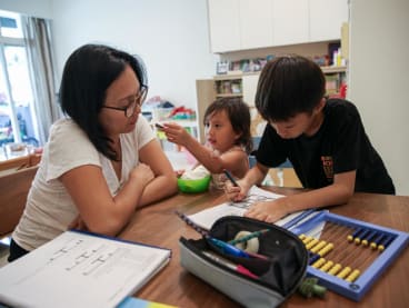 Mrs Diane Lim homeschooling her children Timothy and Mikayla.