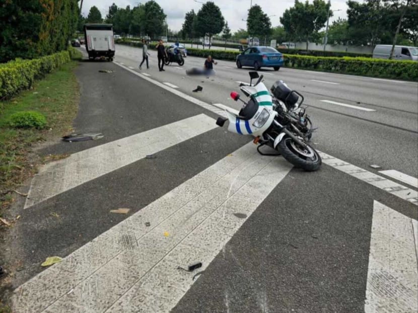 A Land Transport Authority enforcement officer is seen lying on a road after an accident on June 4, 2024.