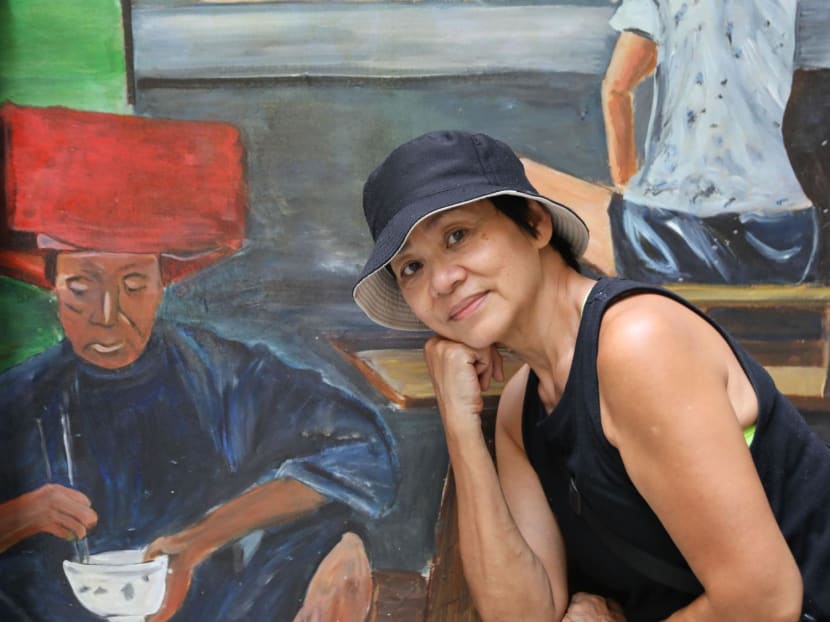 Mural artist Belinda Low posing with one of her artworks in Chinatown on June 26, 2024.