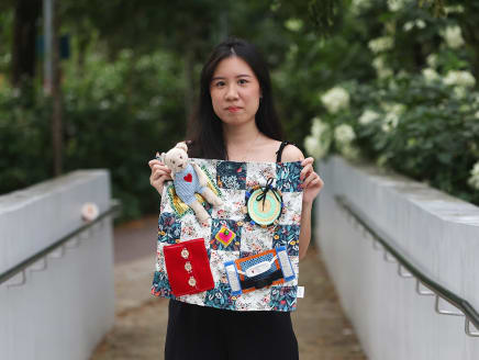 Ms Lydia Han from Rosemadame Craftwork holding a fidget blanket meant for dementia patients.