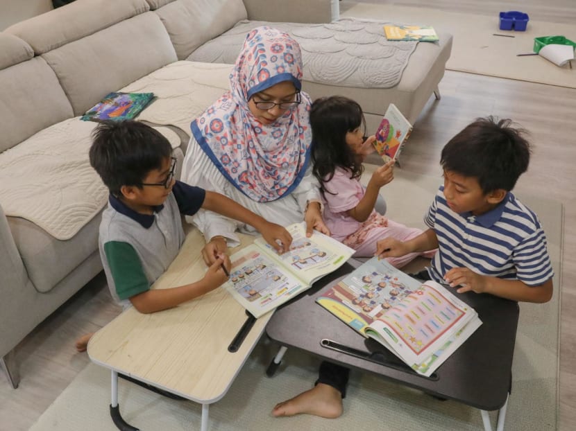 Secondary school Malay language teacher Nur Asyikin Naser reading storybooks in Malay with her children. 