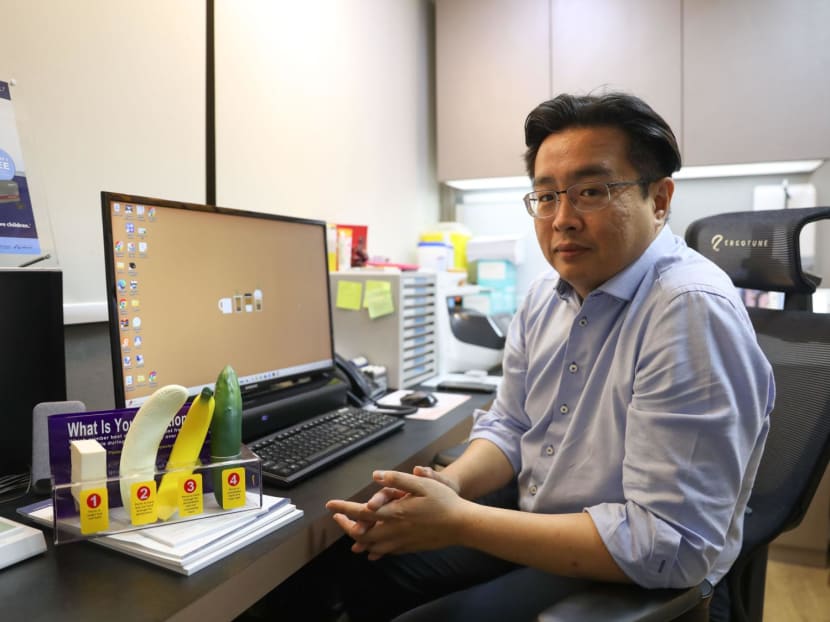 Dr Ronny Tan, president of the Society for Men's Health Singapore, pictured in his office at Parkway East Hospital with props used to help explain erectile dysfunction to patients.