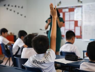 A student raising his hand to answer a question posed by the teacher in a Gifted Education Programme (GEP) class at St. Hilda's Primary School on 28 Aug, 2024.