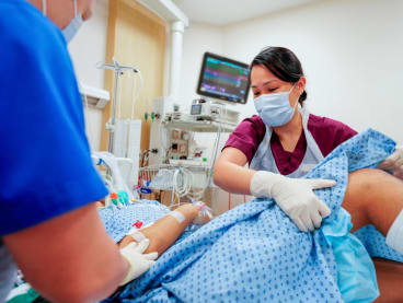 Ms Kwan Peijun, a senior principal physiotherapist, working with a team of nurses to tend to a patient who was treated at the National University Centre for Trauma.