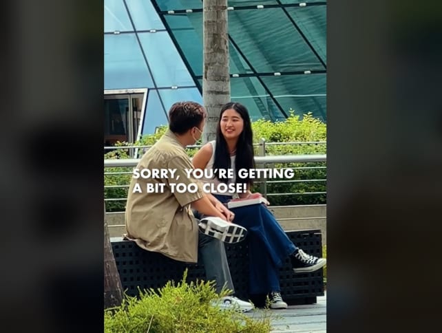 A screenshot from a "social experiment" of a staged incident of a woman being harassed by a man near Marina Bay Sands.